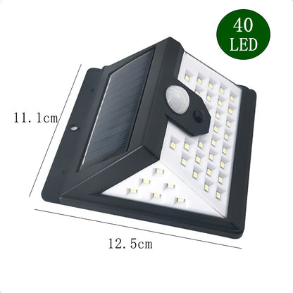 Lámpara de pared solar LED para exteriores, de cuatro caras iluminadas, con sensor de movimiento, ideal para jardines y patios.